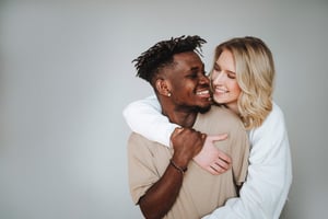 Couple embracing plain background