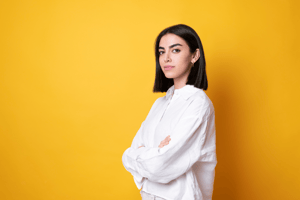Dark haired young woman yellow background
