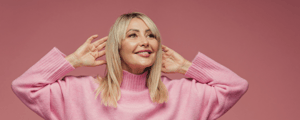 Middle aged woman pink background