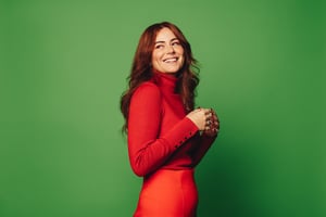 Red headed woman green background
