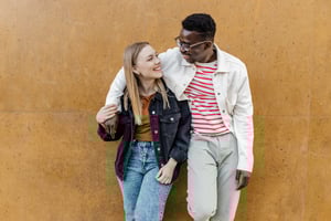 Young couple with arms around eachother